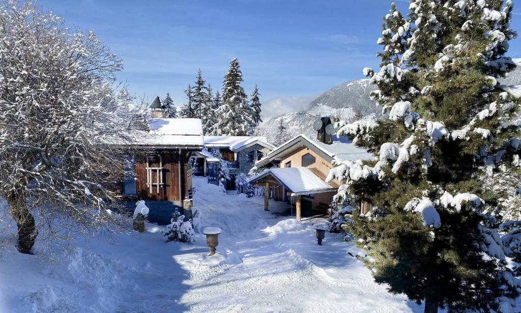 a cabin in the snow with snow covered trees at Le Hameau de Marcandou in Courchevel