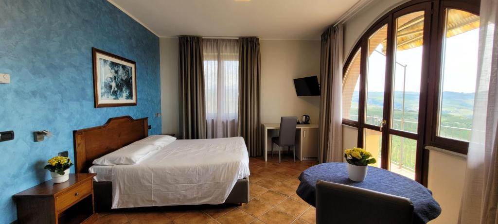 Postel nebo postele na pokoji v ubytování Agriturismo Le Arcate