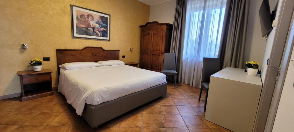 Postel nebo postele na pokoji v ubytování Agriturismo Le Arcate