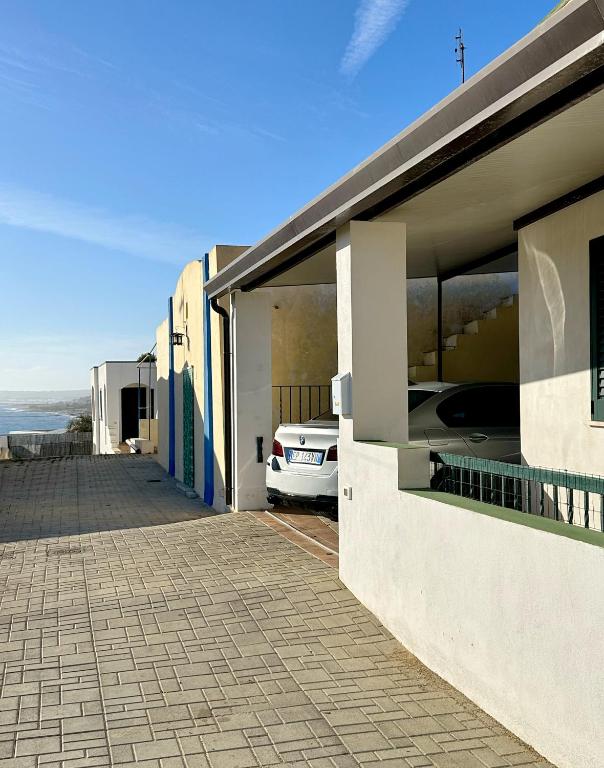 a car is parked outside of a building at Sunset Salentorelax San Gregorio in Marina San Gregorio