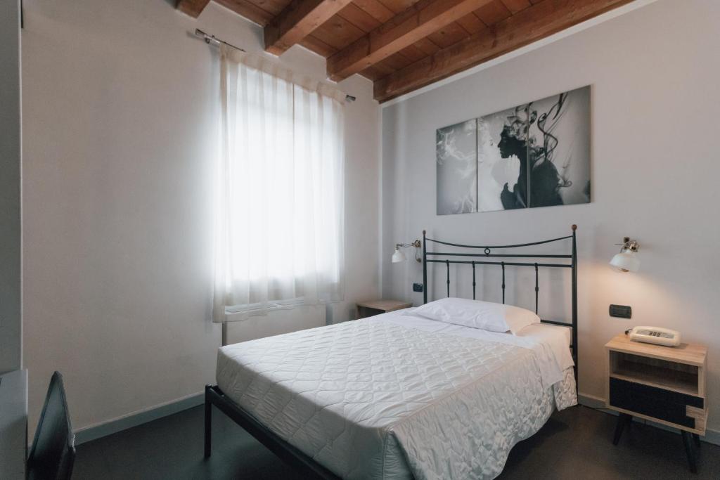 Postel nebo postele na pokoji v ubytování Hotel Gattopardo