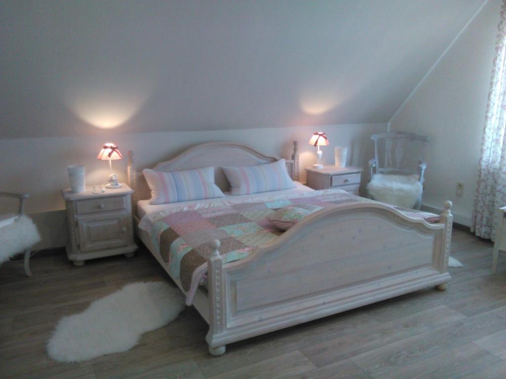 a bedroom with a bed with two night stands and two lamps at Apartment Seaside in Husum