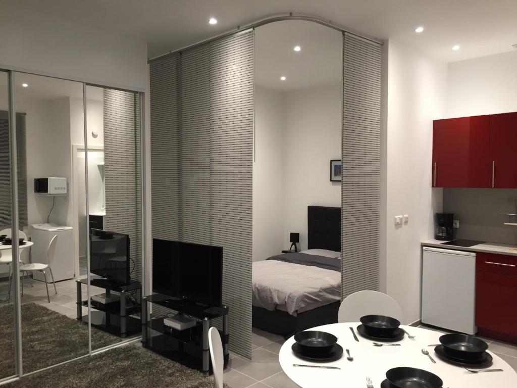 a bedroom with a bed and a table and a mirror at Nice Renting - GALLO - New Modern Loft Old Town Massena in Nice