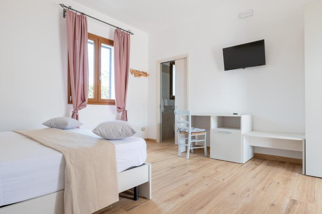 Postel nebo postele na pokoji v ubytování Borgo Specchia Natural Resort