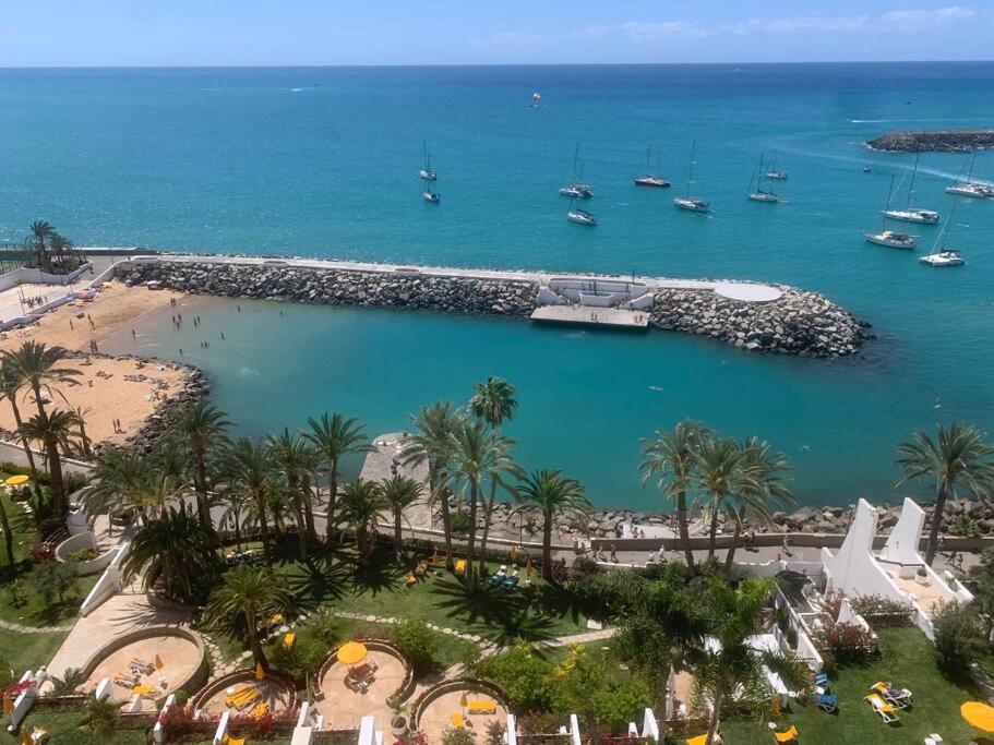a view of a beach and a harbor with boats at Penthouse Urbanizacion Montemarina Anfi del Mar in Mogán