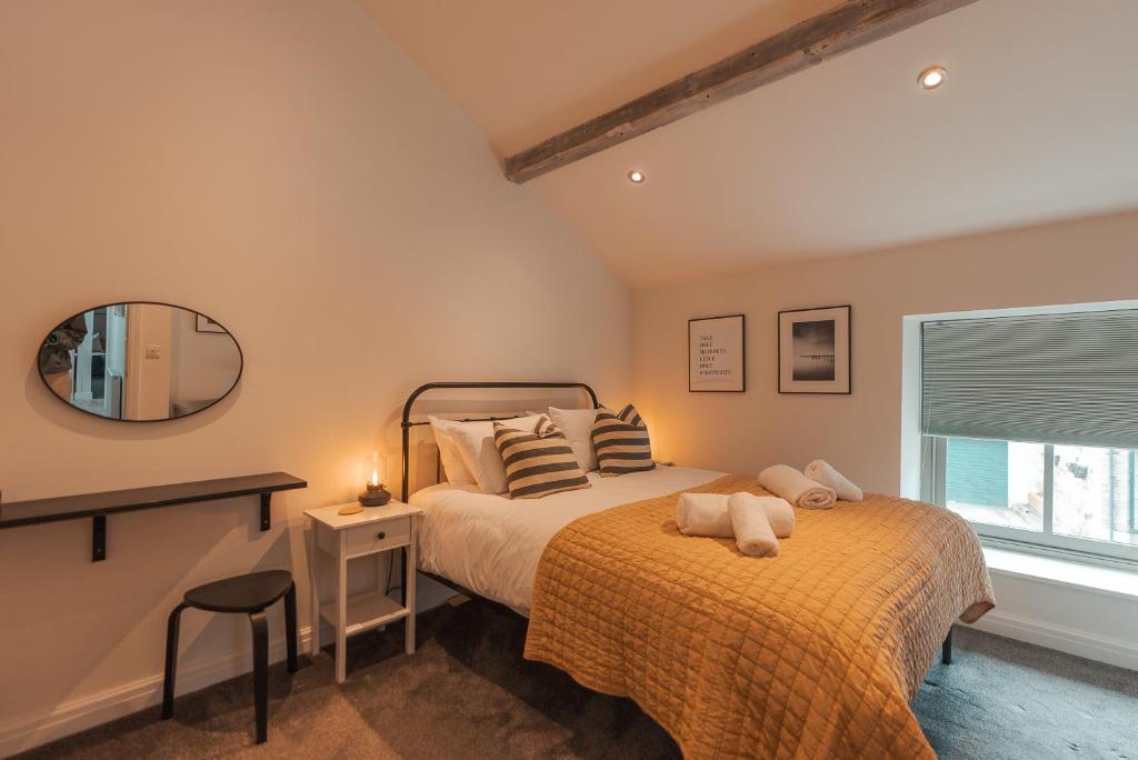 a bedroom with a bed and a mirror at Bridge Apartment in Stockport