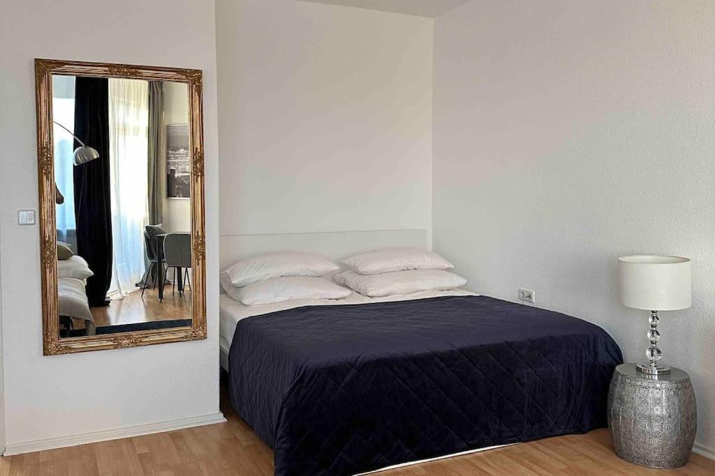 a bedroom with a bed and a mirror at City Apartment am Ku'damm & ICC Messe/Free Parking in Berlin