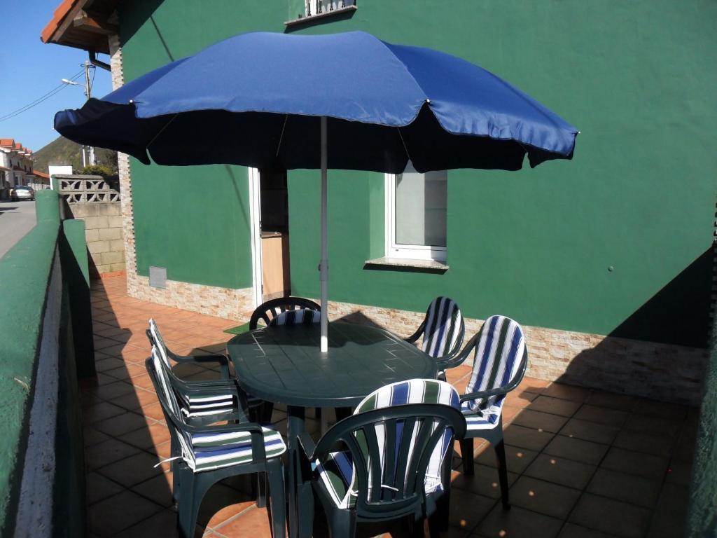 a table and chairs under an umbrella on a patio at Casa Pepe El Segador - VV-1054-AS in San Juan de la Arena