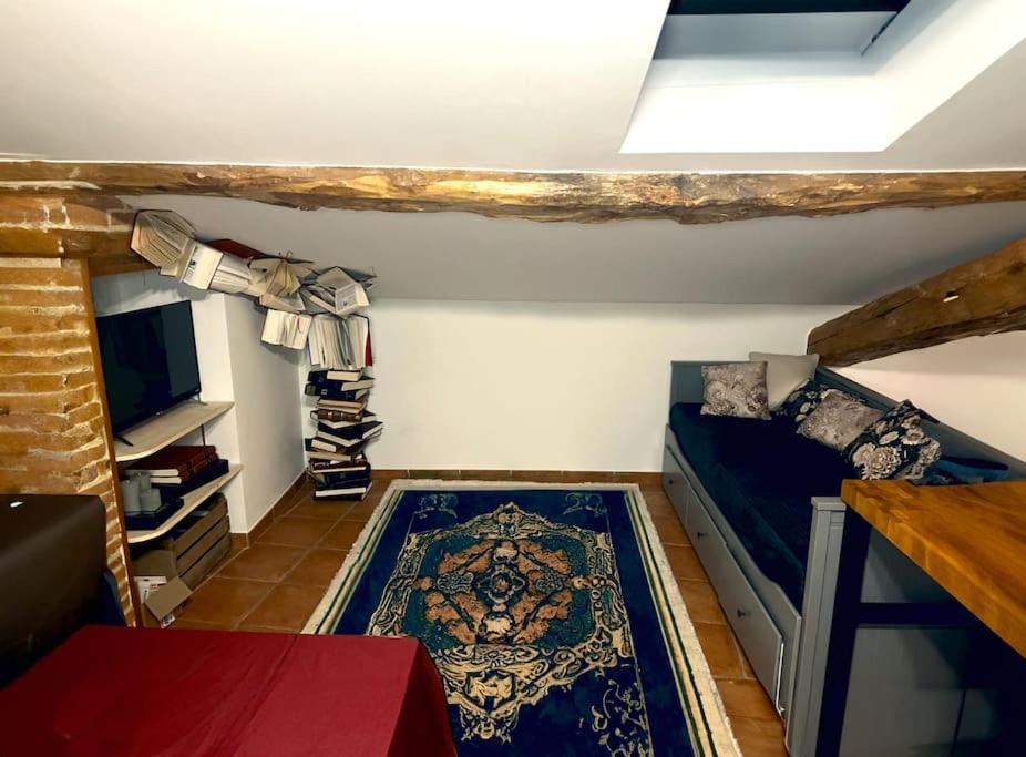 Kleines Zimmer mit einem Bett und einem TV in der Unterkunft Le sanctuaire des sorciers in Calmont