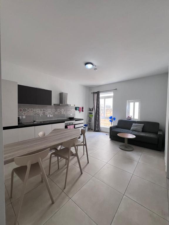 a living room with a table and a couch at Sunshine Court Apartment No 1 in Sliema