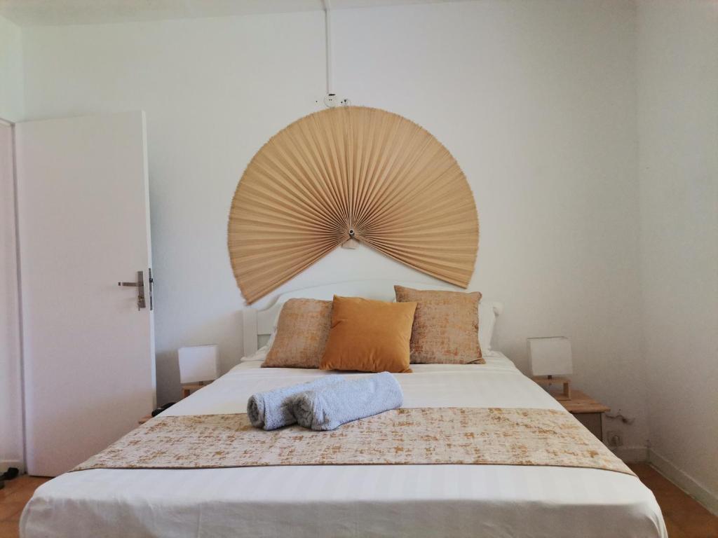 a bedroom with a bed with a large fan above it at Vilalea - Maison de vacances 8 pers in Petit-Bourg