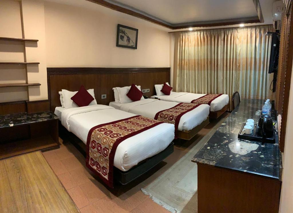 Postel nebo postele na pokoji v ubytování Hotel Manang