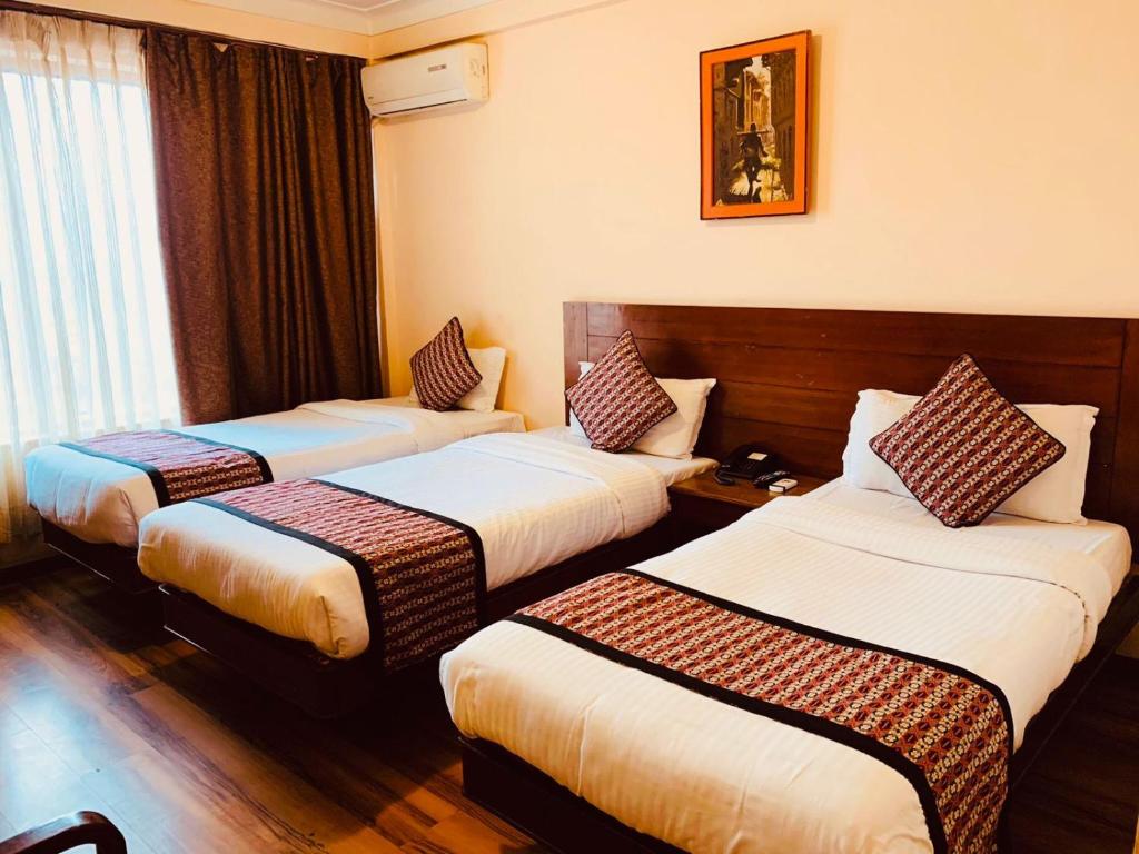 Postel nebo postele na pokoji v ubytování Hotel Manang