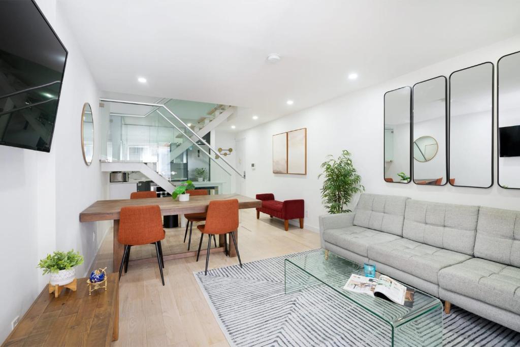 a living room with a couch and a table at 75-4B Duplex 3BR Brand new W D Prime UES in New York
