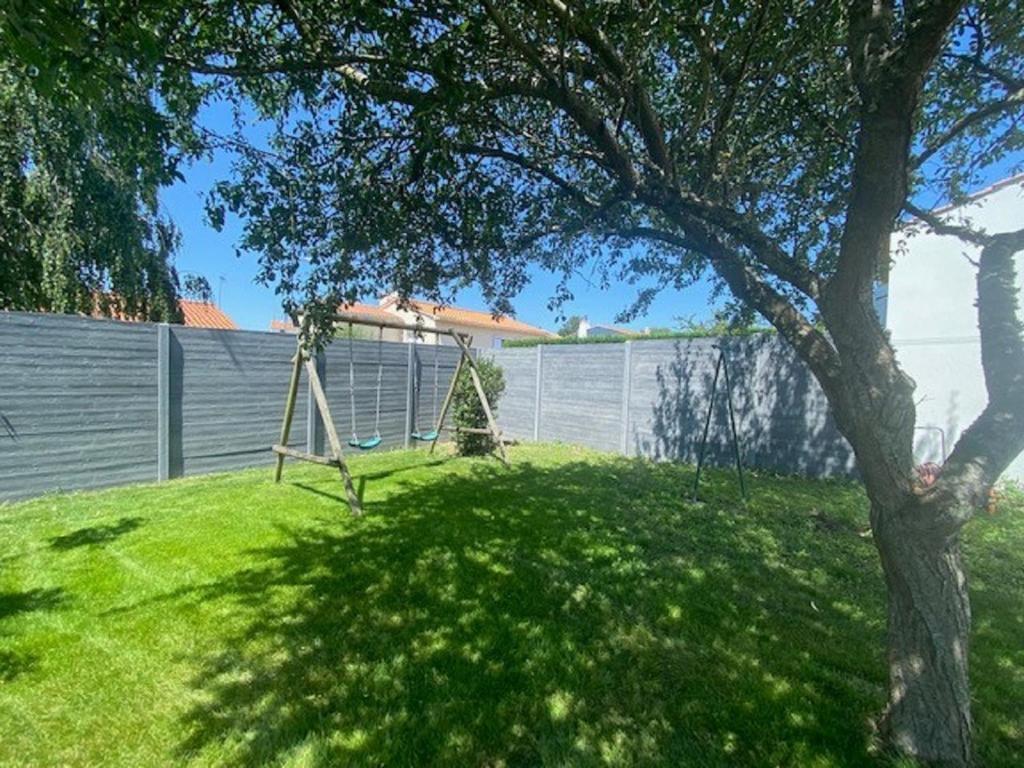 a yard with a tree and a swing at Maison 6 personnes au calme quartier Val in Le Fenouiller