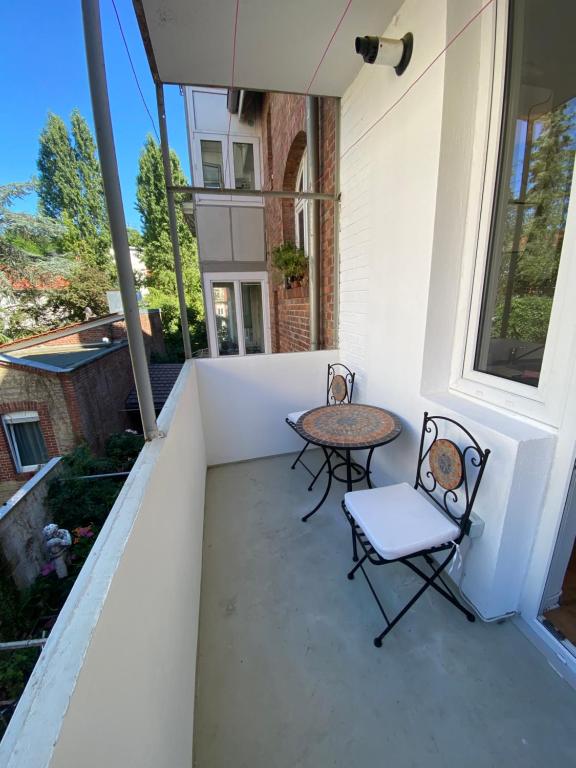 two chairs and a table on a balcony at Schöner Wohnen in Stuttgart Ost in Stuttgart