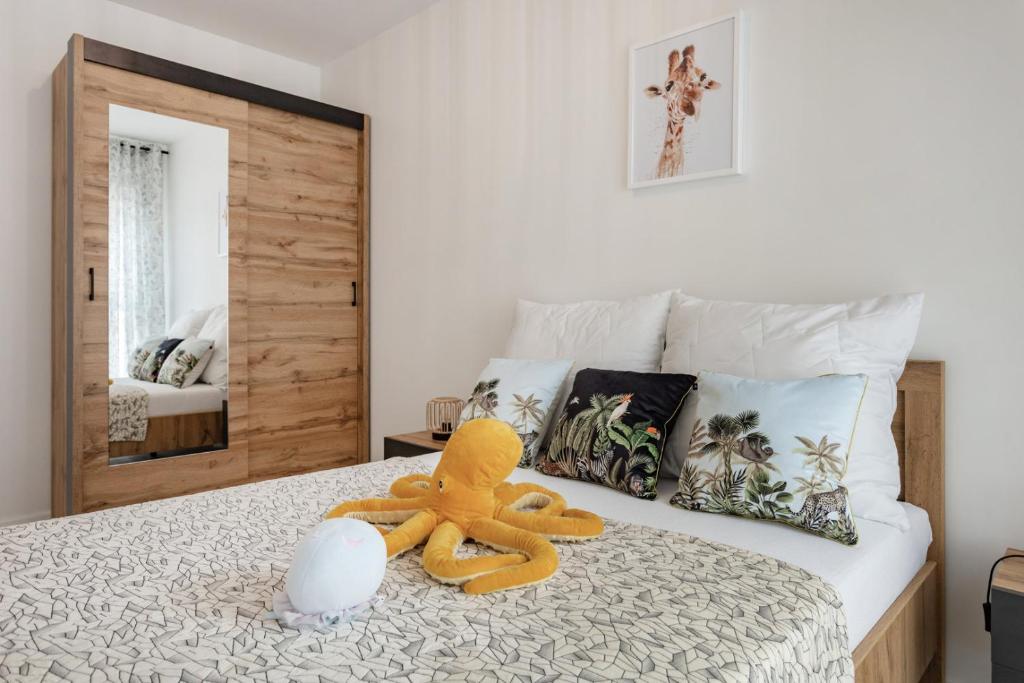 a teddy bear sitting on top of a bed at Apartament Fauna- blisko morza in Gdańsk