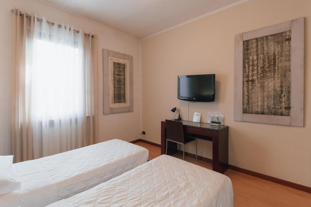 TV a/nebo společenská místnost v ubytování Hotel Gattopardo
