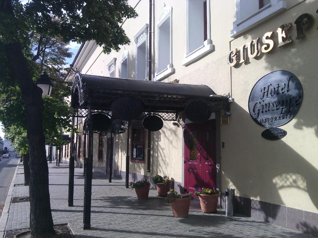 a building with an awning on the side of a street at Giuseppe Hotel in Kazan