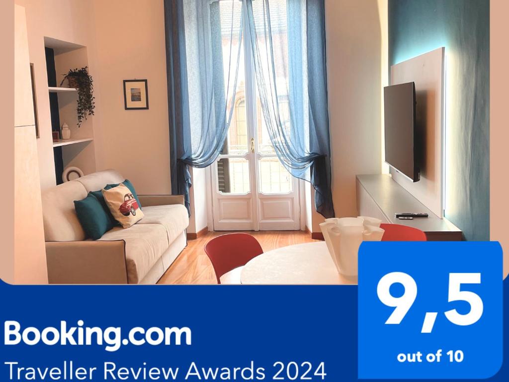 a living room with a couch and a tv at Margarita Apartment Stazione Porta Susa Torino in Turin