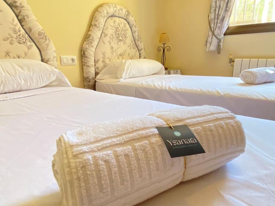 een hotelkamer met twee bedden met een bord erop bij La Casita in Chiclana de la Frontera