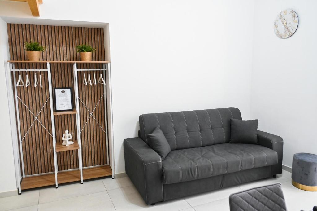 a living room with a couch and a chair at Victry's Houses Chiaia in Naples