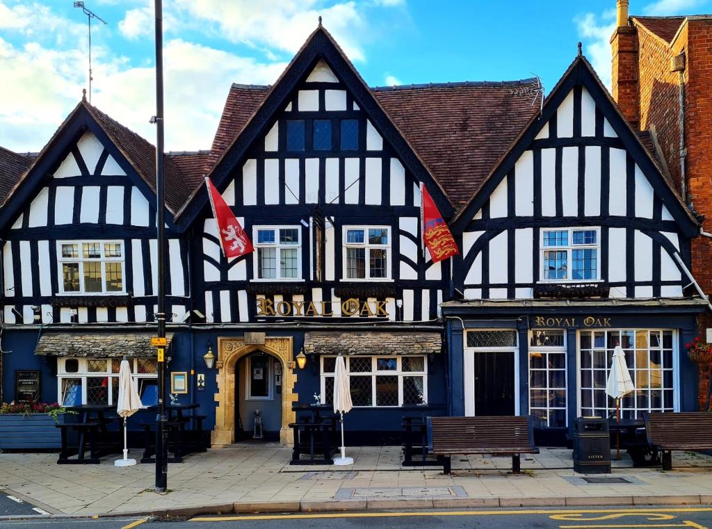 an old black and white building with two flags at The Royal Oak in Evesham