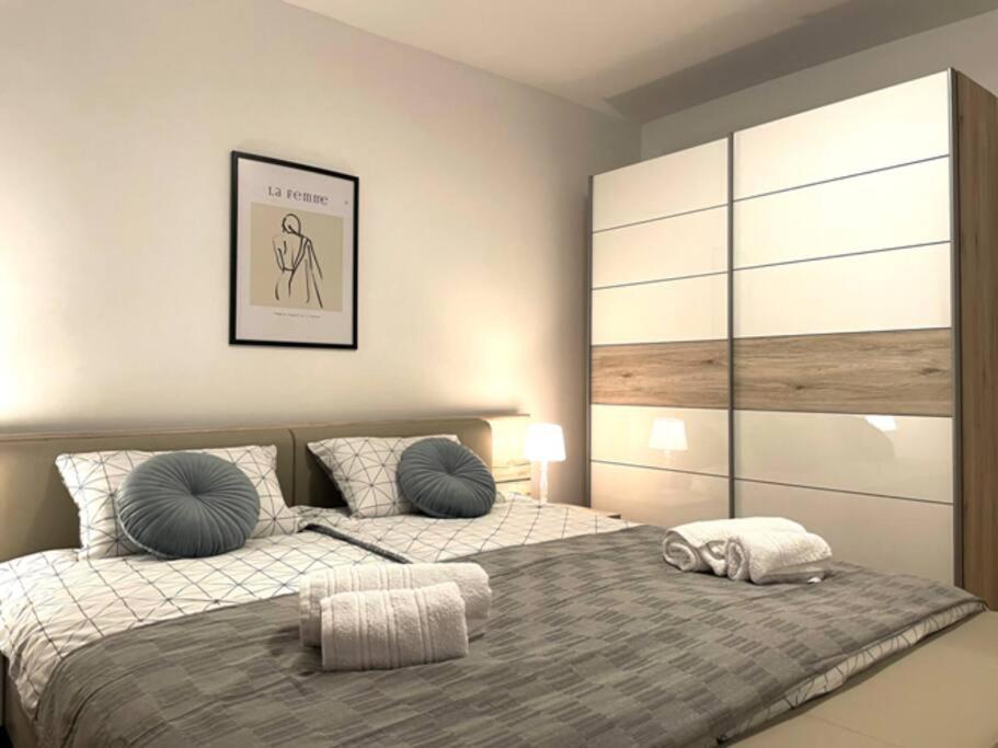 a bedroom with a bed with two pillows on it at Apartman Neva ,prostrani stan u blizini mora in Pula
