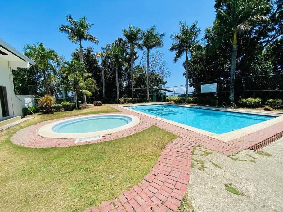 a swimming pool in the yard of a house at SpittlerVilla in Talisay