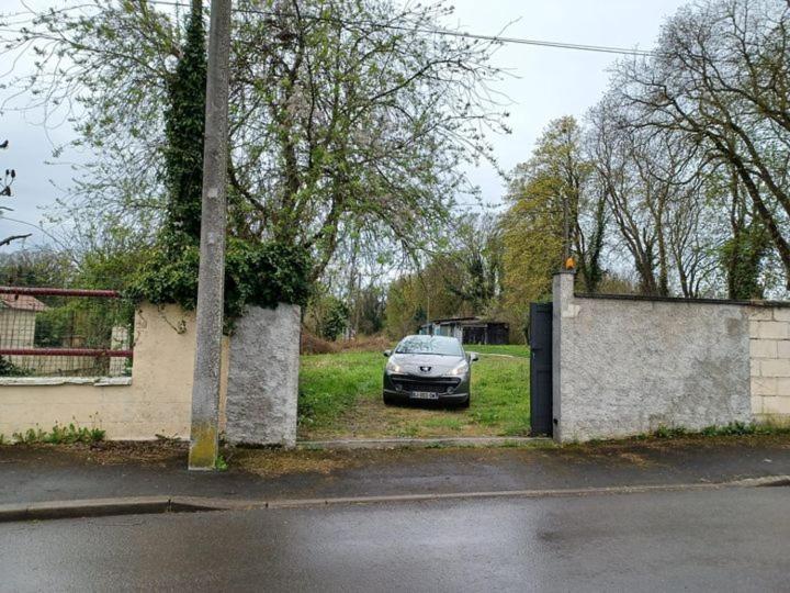 a car parked in the driveway of a house at Jardin de la Cerisaie in Reims