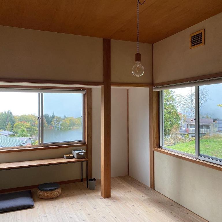 an empty room with two windows in a house at Togaku Hokosha - Vacation STAY 15767 in Nagano