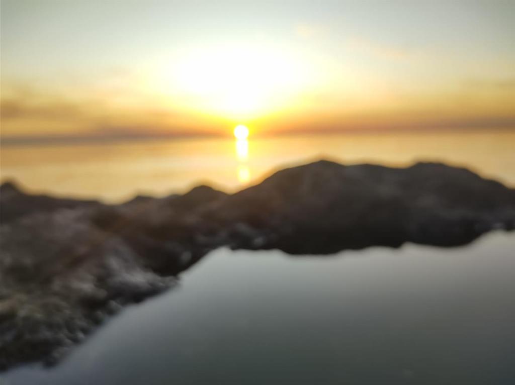 a view of the sun setting over the mountains at Apart Pelusa in Fray Bentos