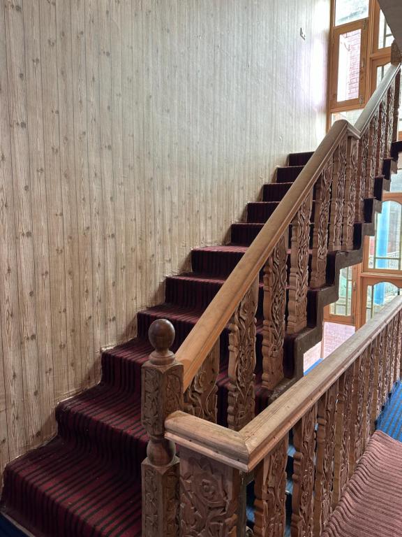 a staircase in a building with brown and red stripes at HOTEL MERLIN PALACE in Srinagar
