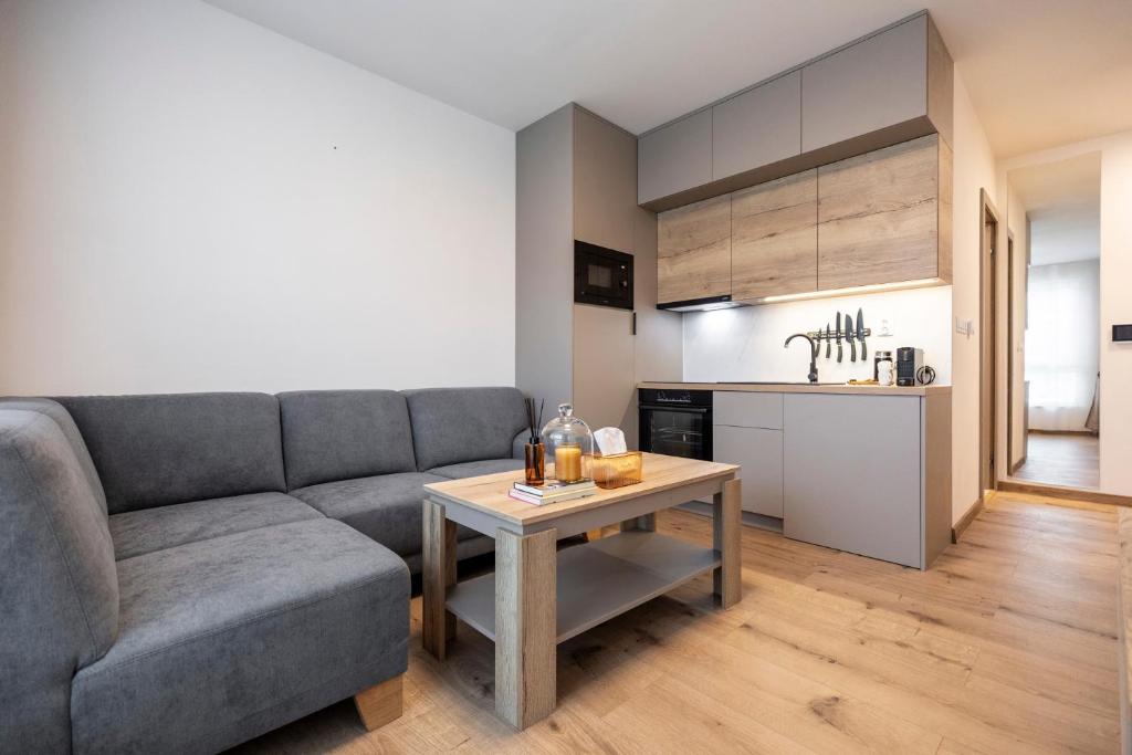 a living room with a couch and a table at ALURE RESIDENCES 5 & 24h self check-in with private parking in Banská Bystrica