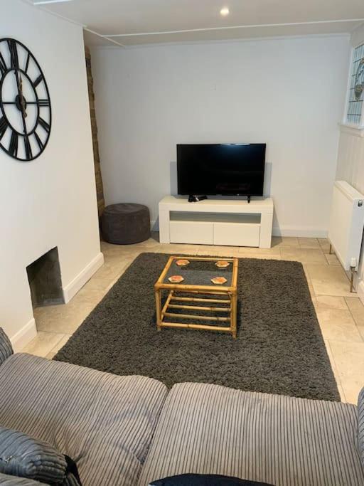 a living room with a couch and a coffee table at Cosy 2 bedroom Cottage in Saint Dogmaels- river views in Cardigan