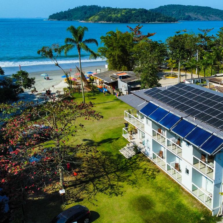 an aerial view of a resort with solar panels on the beach at Pousada Cantinho da Praia in Paraty