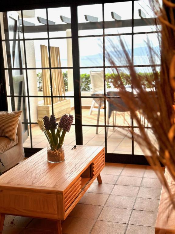 a coffee table in a living room with a large window at Anna in L'Escala