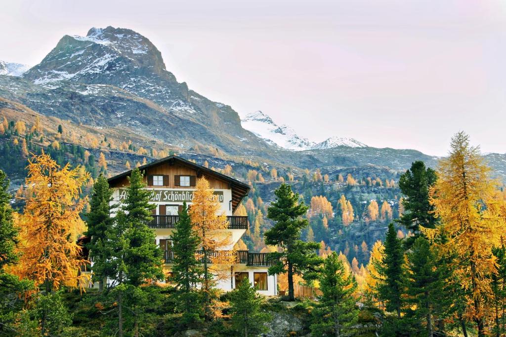 a house on a hill with a mountain in the background at Bellavista Schönblick in Casere alte del Piano