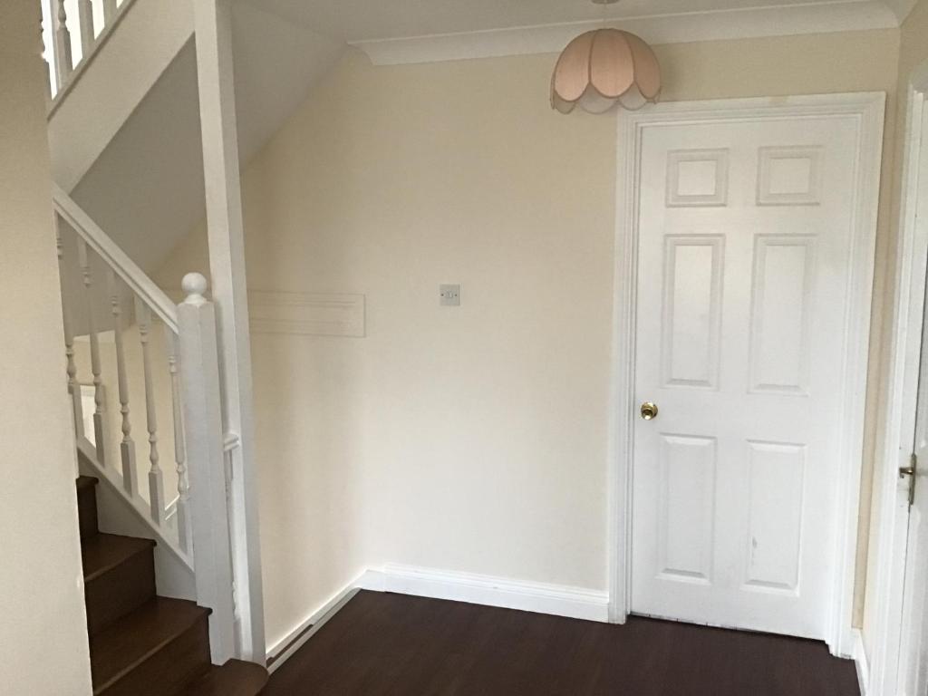a hallway with a white door and stairs at Captivating 8-Bed House in Porthleven in Porthleven