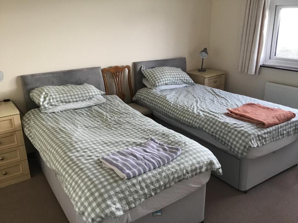 two twin beds in a room with at Captivating 8-Bed House in Porthleven in Porthleven
