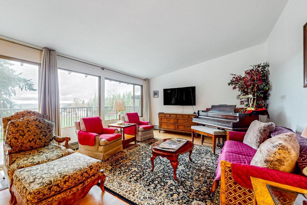 a living room with a couch and a piano at Pacific Prairie in Woodinville