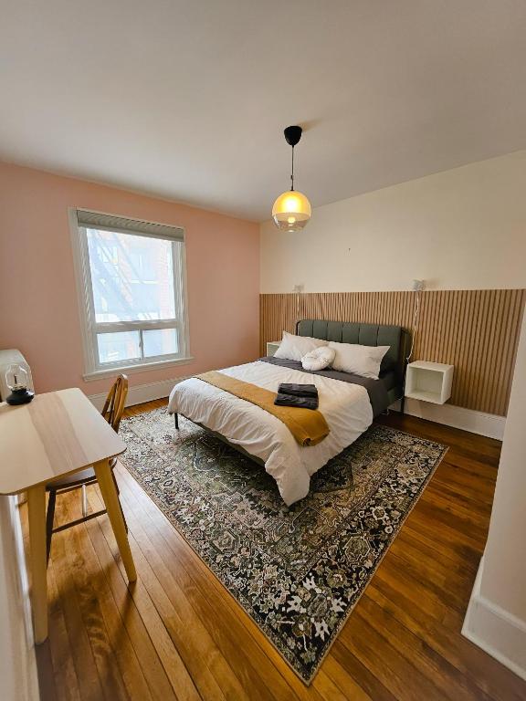 a bedroom with a bed and a rug at Ottawa Downtown Cozy Guesthouse in Ottawa