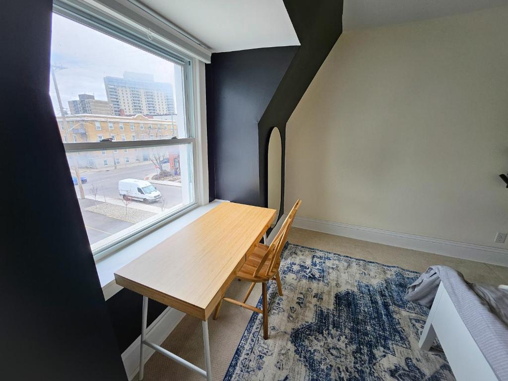 a desk in a room with a large window at Ottawa Downtown Cozy Guesthouse in Ottawa