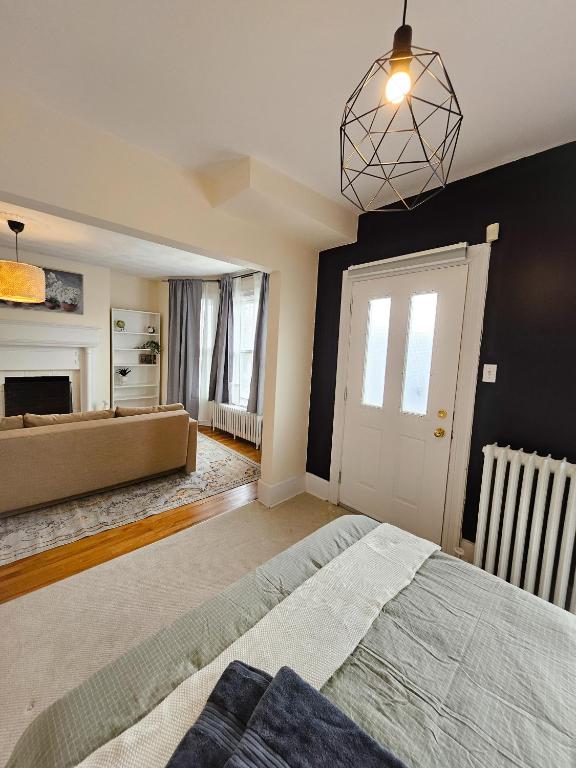 a bedroom with a large bed and a fireplace at Ottawa Downtown Cozy Guesthouse in Ottawa