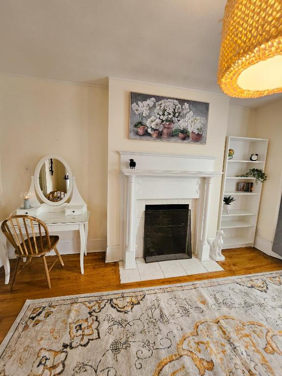 a living room with a fireplace and a mirror at Ottawa Downtown Cozy Guesthouse in Ottawa