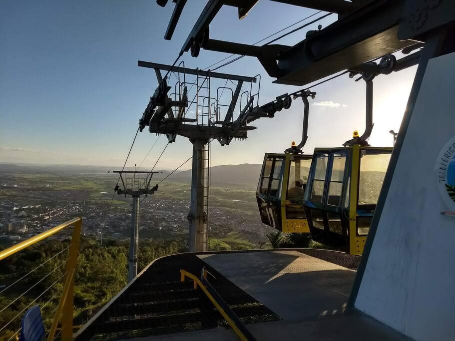 a gondola lift with two people riding on it at Bonito/PE pelo Airbnb 1 in Bonito