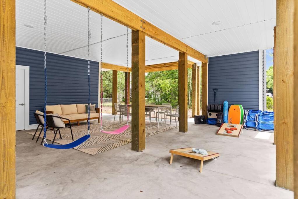 a room with a patio with a table and chairs at Live Oak Villa~OKI Beach Retreat in Oak Island