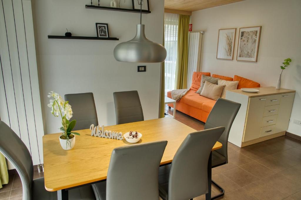 a dining room with a wooden table and chairs at Apartma Pikabooth in Topolšica