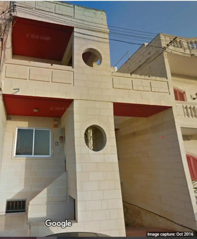 a building with a face on the side of it at Luqa Premium Rooms in Luqa