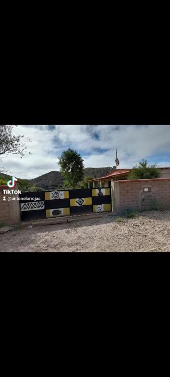 a fence with a sign in front of a building at TINKUNAKAMA in Humahuaca
